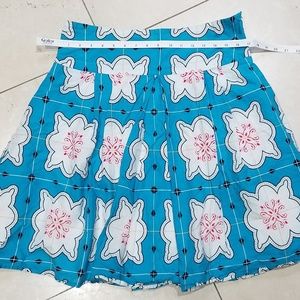 Turquoise Skirt with Red, Black White designs.